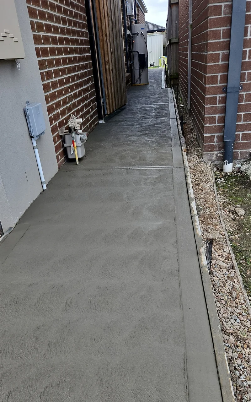 Concrete side path and surrounds beside a Southeast Melbourne home